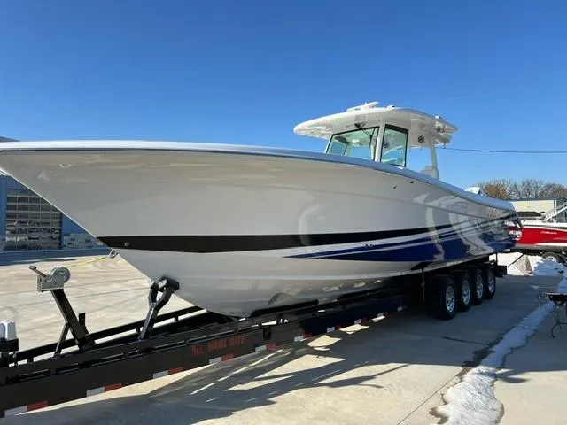 Slide: The Image of 2023 HCB 39 Speciale boat on a trailer under clear blue sky. - 16