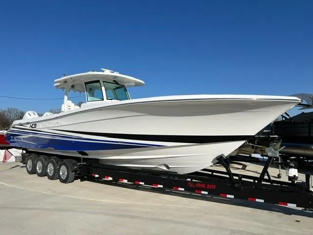 Slide: The Image of 2023 HCB 39 Speciale boat on a trailer under clear blue sky. - 17