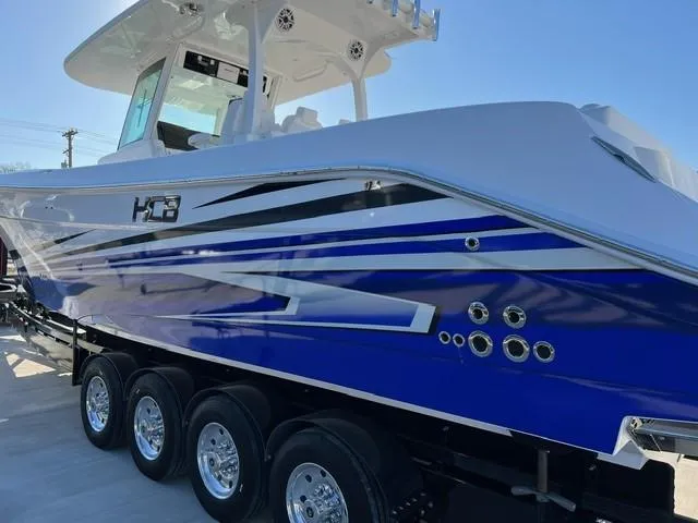 Slide: The Image of 2023 HCB 39 Speciale boat with blue and white exterior on a trailer. - 2