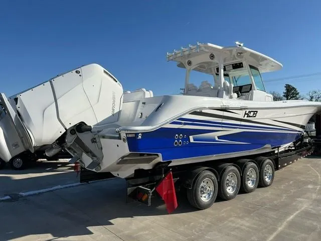 Slide: The Image of 2023 HCB 39 Speciale boat on trailer with triple outboard engines. - 3