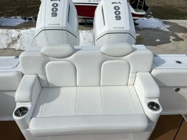 Slide: The Image of 2023 HCB 39 Speciale boat with white cushioned seating and twin Mercury 600 engines. - 9