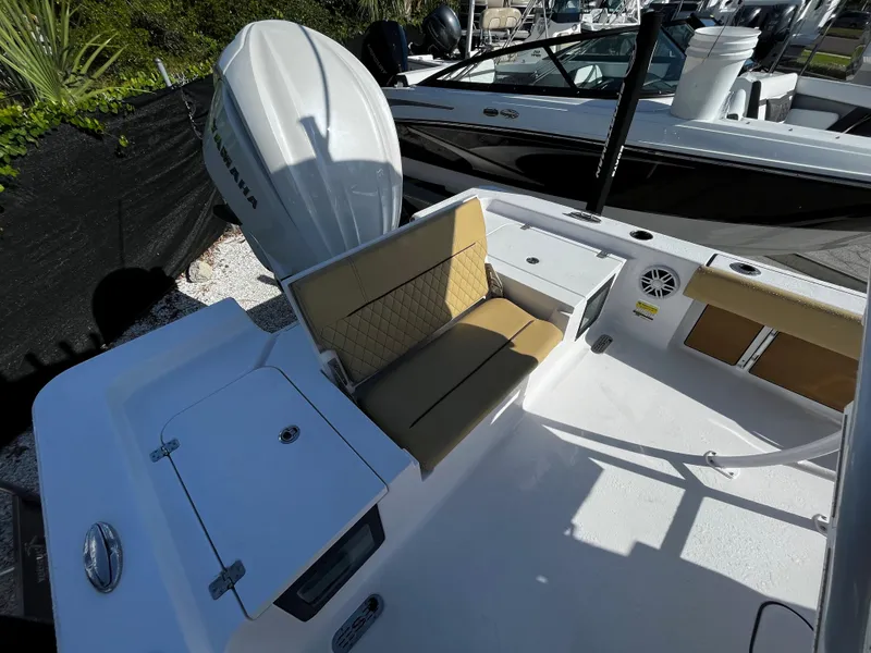 Slide: The Image of 2024 Sportsman Masters 247OE Bay Boat with cushioned seating and Yamaha outboard motor. - 5