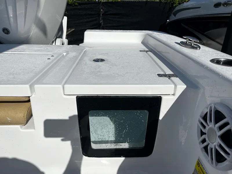 Slide: The Image of 2024 Sportsman Masters 247OE Bay Boat deck with storage compartments and speaker. - 6