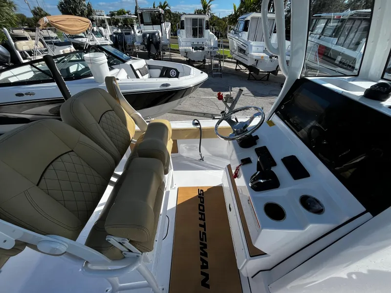 Slide: The Image of 2024 Sportsman Masters 247OE Bay Boat interior with helm and seating. - 7