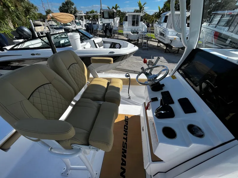 Slide: The Image of 2024 Sportsman Masters 247OE Bay Boat interior with dual seats and control console. - 8