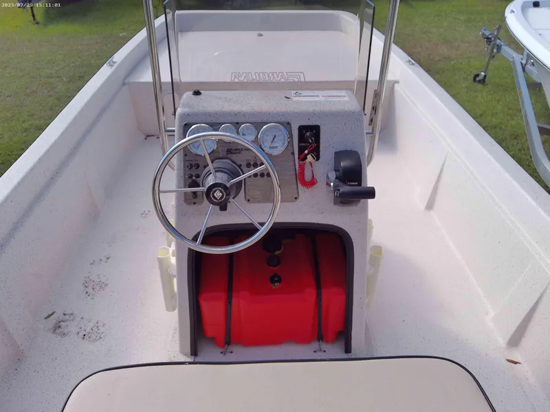 Slide: The Image of 2024 Carolina Skiff e21 DLX boat console with steering wheel and gauges. - 5