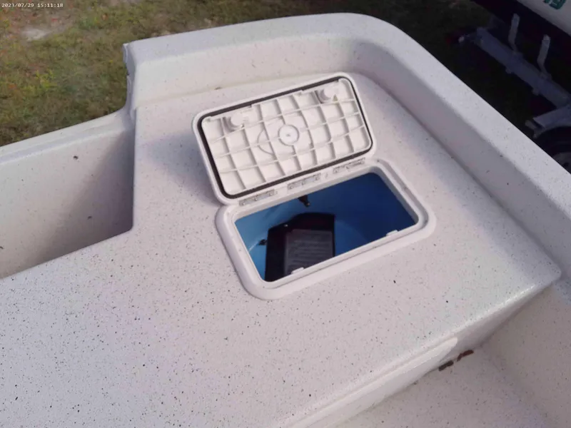 Slide: The Image of 2024 Carolina Skiff e21 DLX boat storage compartment with open hatch. - 6