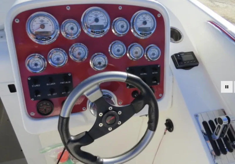 Slide: The Image of Control panel of a 2007 Challenger DDC 33 boat with steering wheel and gauges. - 10