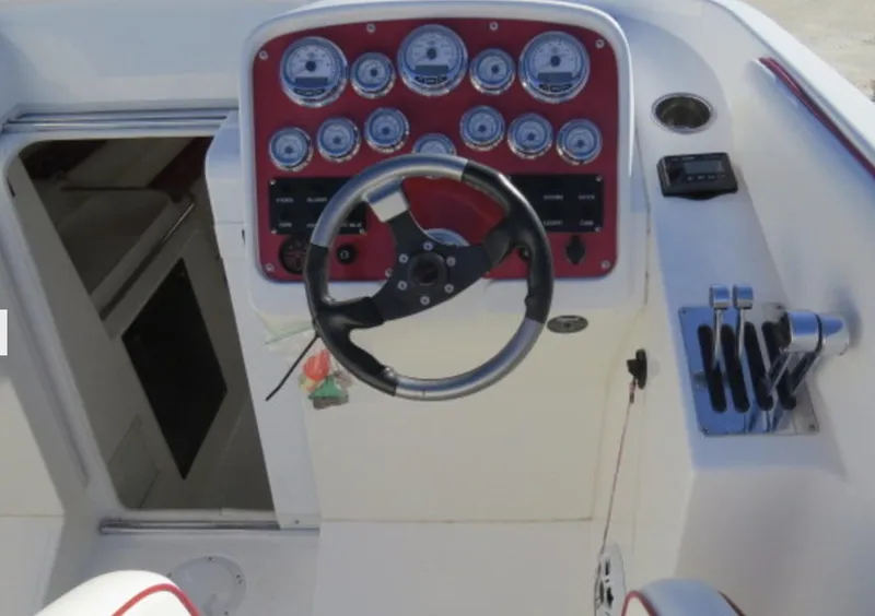Slide: The Image of 2007 Challenger DDC 33 boat cockpit with steering wheel and control panel. - 19