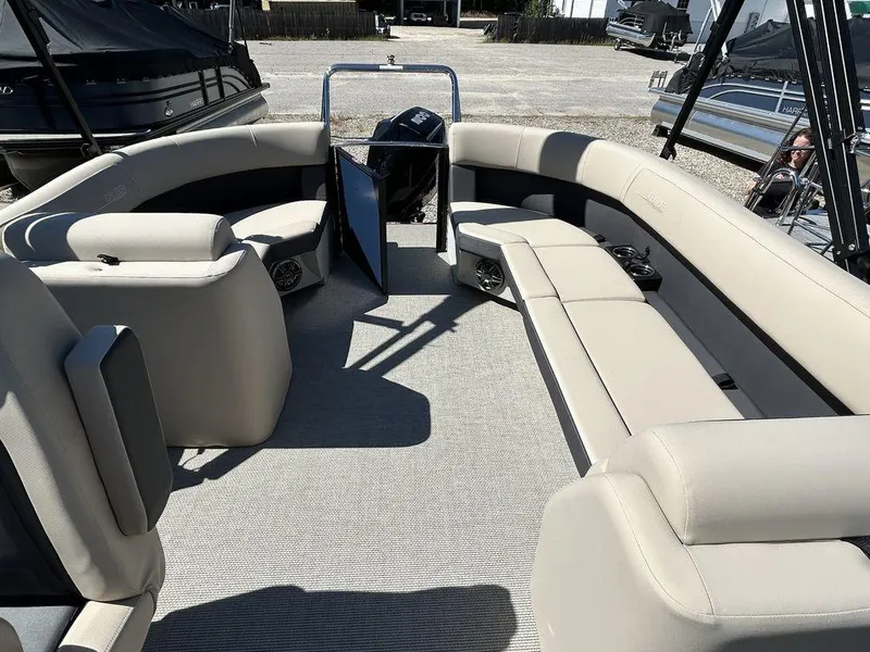 Slide: The Image of 2024 Harris Cruiser 230 pontoon boat interior with beige seating and open deck layout. - 11