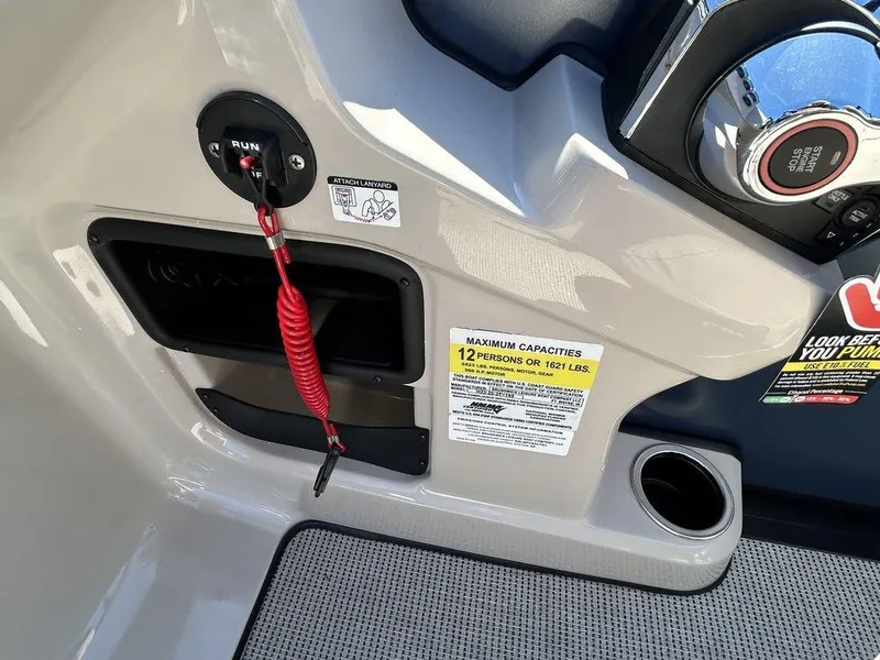 Slide: The Image of 2024 Harris Cruiser 230 boat dashboard with safety features and capacity label. - 14