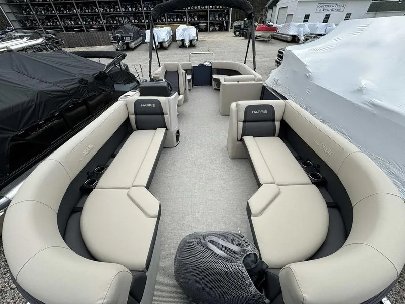 Slide: The Image of 2024 Harris Cruiser 230 pontoon boat with spacious seating and modern design. - 4