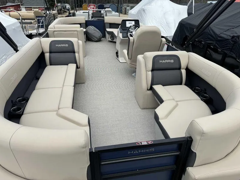 Slide: The Image of 2024 Harris Cruiser 230 pontoon boat with spacious seating and modern interior design. - 7