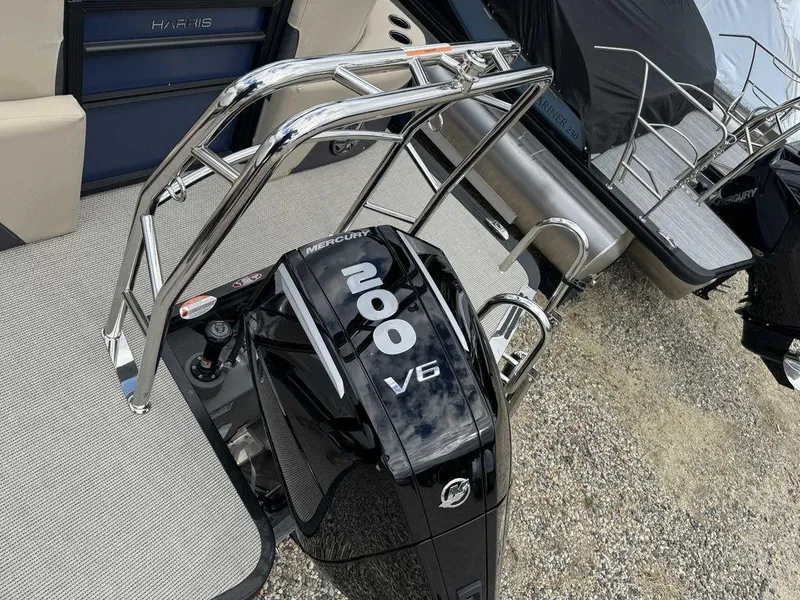 Slide: The Image of 2024 Harris Cruiser 230 with Mercury 200 V6 engine, docked on textured flooring. - 9