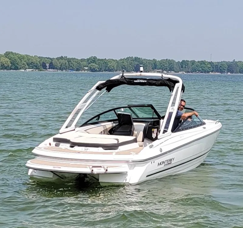 Slide: The Image of 2023 Monterey 224FS boat cruising on a lake. - 2