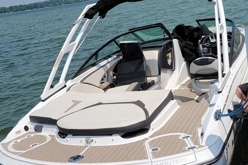 Slide: The Image of 2023 Monterey 224FS boat on water, featuring spacious seating and modern design. - 4