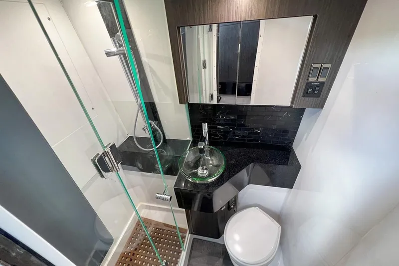Slide: The Image of Luxurious 2024 Mystic Powerboats M5200 bathroom with modern glass shower and sleek fixtures. - 7