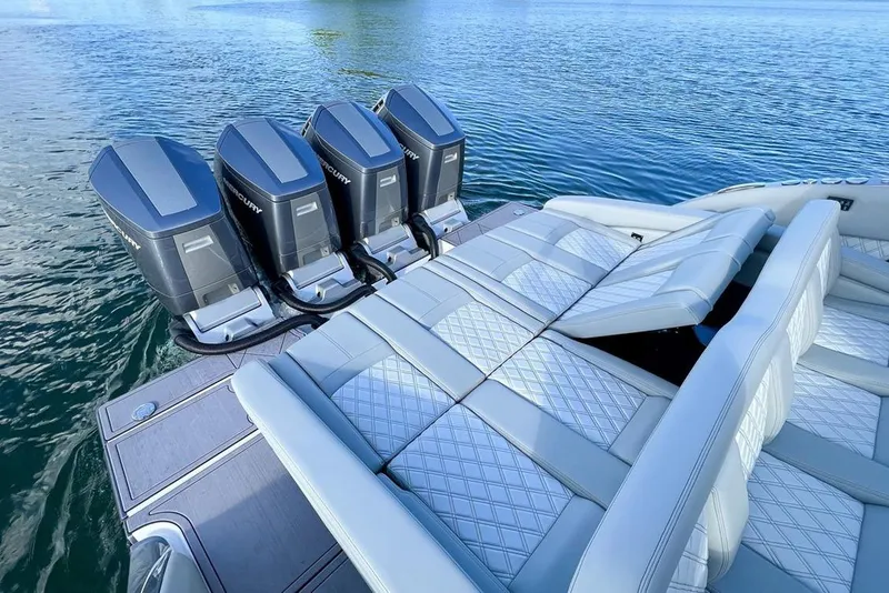 Slide: The Image of 2024 Mystic Powerboats M5200 with four outboard engines on calm water. - 8