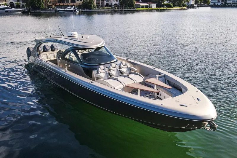 Slide: The Image of 2024 Mystic Powerboats M5200 luxury boat cruising on calm waters. - 9