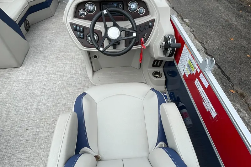 Slide: The Image of 2022 Berkshire 24RFXLE25 boat cockpit with steering wheel and captain's chair. - 3