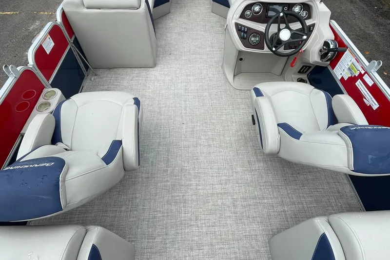 Slide: The Image of 2022 Berkshire 24RFXLE25 pontoon boat interior with plush seating and modern helm. - 4