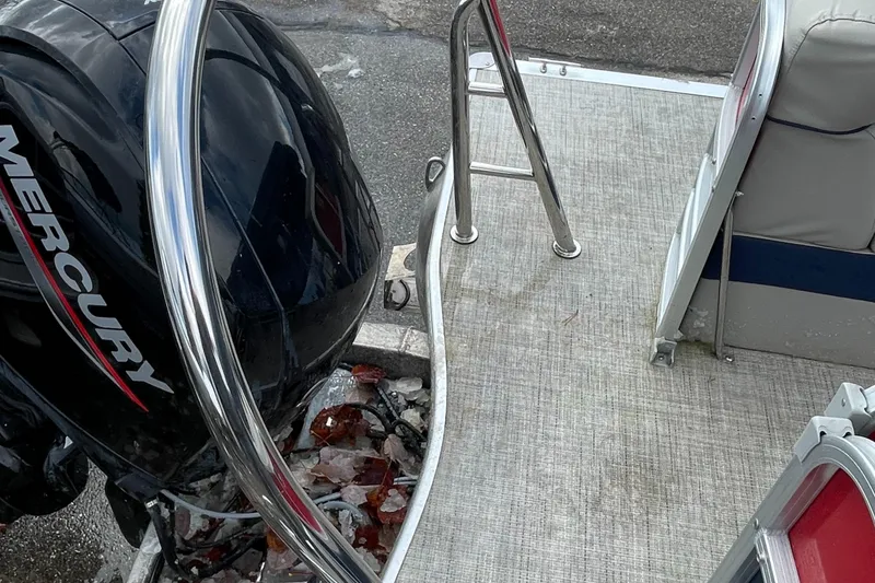 Slide: The Image of 2022 Berkshire 24RFXLE25 boat with Mercury outboard motor and rear deck ladder. - 6