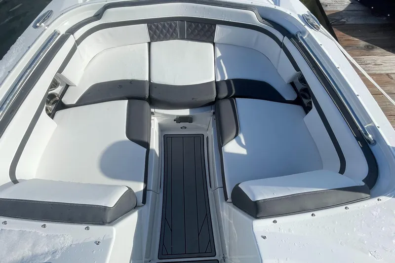 Slide: The Image of 2024 Monterey M4 boat interior with white and black cushioned seating. - 4