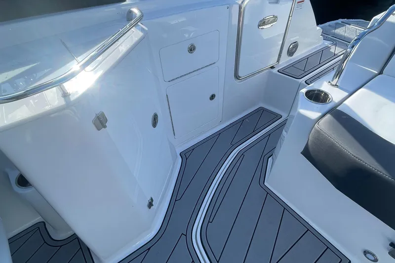 Slide: The Image of 2024 Monterey M4 boat interior with sleek white cabinetry and gray flooring. - 6