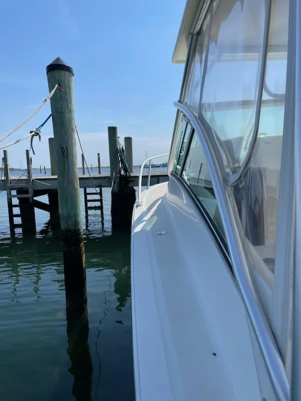 Slide: The Image of 2008 Albemarle 31 boat docked at a marina on a sunny day. - 10