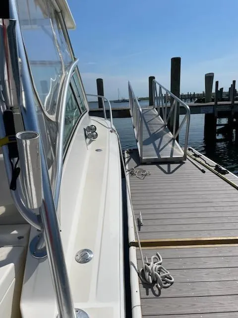 Slide: The Image of 2008 Albemarle 31 boat docked at a marina with clear blue skies. - 11