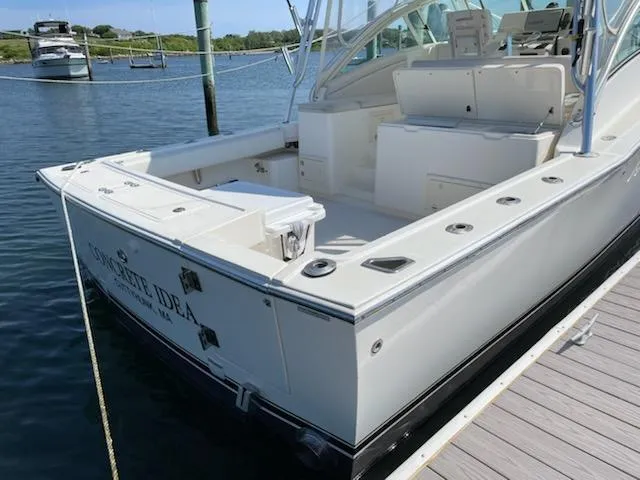 Slide: The Image of 2008 Albemarle 31 boat docked, featuring spacious deck and seating area. - 13
