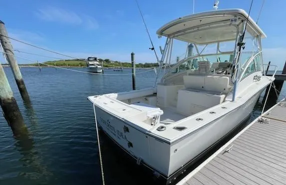 Slide: The Image of 2008 Albemarle 31 boat docked in a marina under clear blue skies. - 14