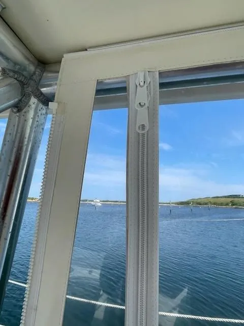 Slide: The Image of View from 2008 Albemarle 31 boat window overlooking calm waters and blue sky. - 15
