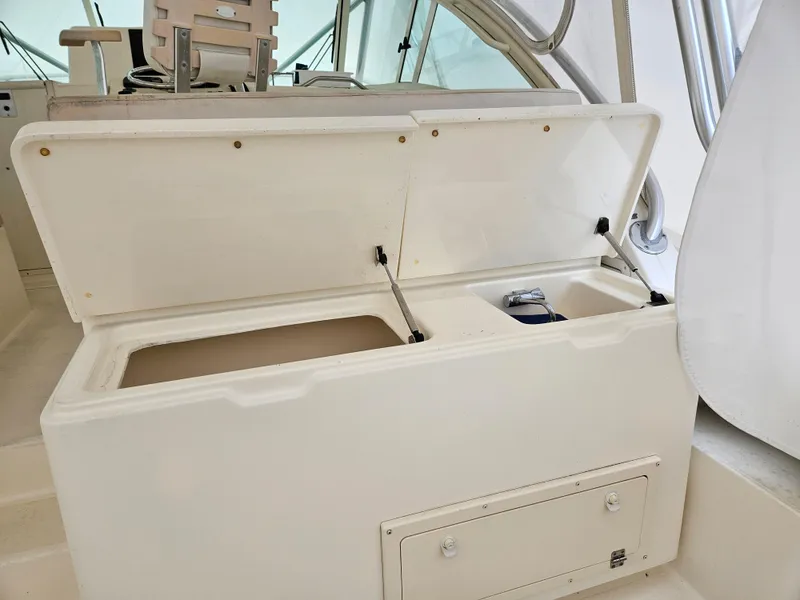 Slide: The Image of Open storage compartment on 2008 Albemarle 31 boat, featuring dual sections and a latch. - 16