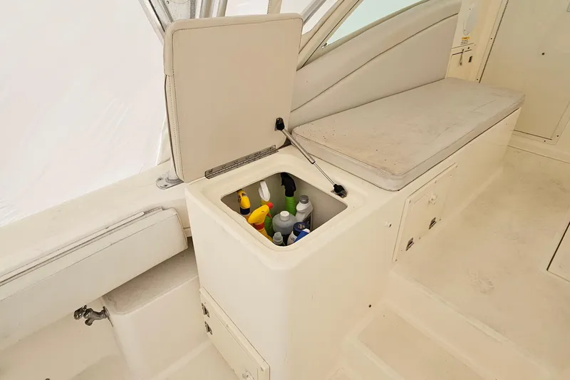 Slide: The Image of 2008 Albemarle 31 boat interior with storage compartment and seating area. - 17