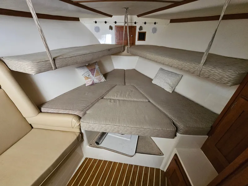 Slide: The Image of Interior of 2008 Albemarle 31 boat with cushioned seating and wooden accents. - 18