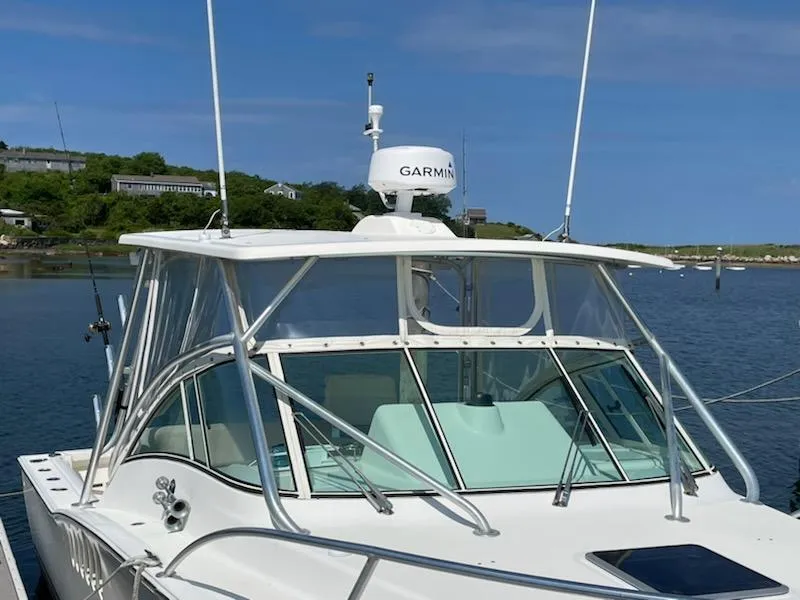 Slide: The Image of 2008 Albemarle 31 boat docked, featuring Garmin radar, clear skies, and scenic waterfront. - 2