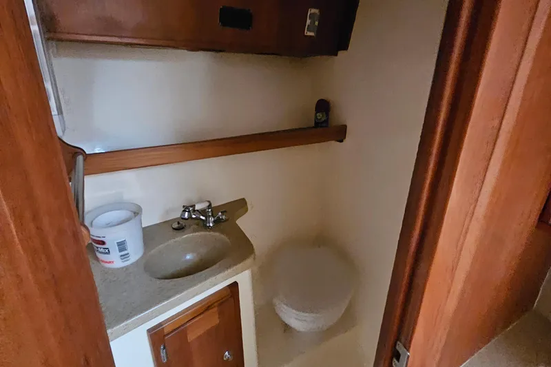 Slide: The Image of Compact bathroom in 2008 Albemarle 31 boat with sink and storage. - 20