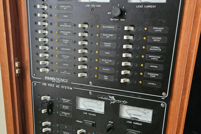 Slide: The Image of Control panel of a 2008 Albemarle 31 boat, featuring switches and gauges. - 21