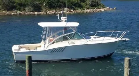 Slide: The Image of 2008 Albemarle 31 boat cruising on a calm, scenic waterway. - 3