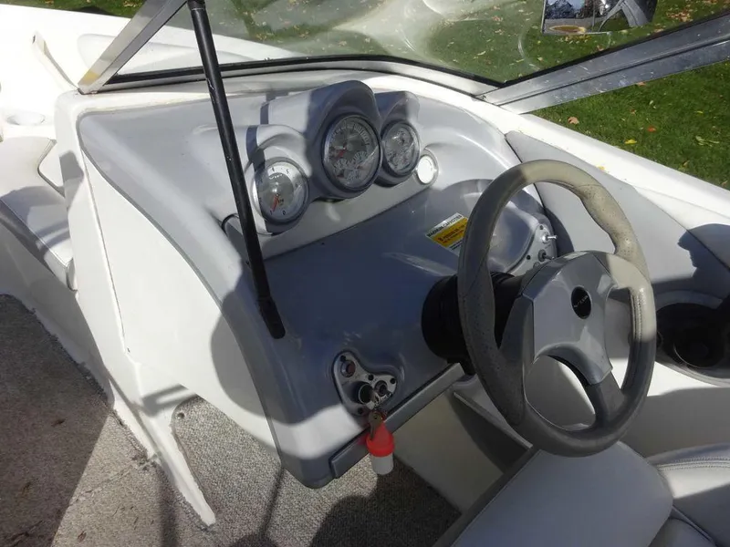Slide: The Image of 2004 VIP 185 Vegas boat dashboard with steering wheel and gauges. - 11