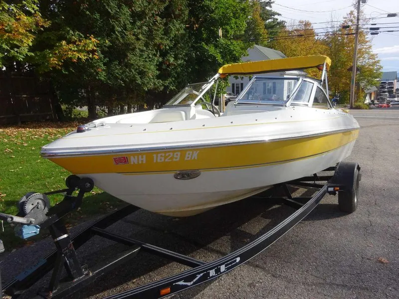 Slide: The Image of 2004 VIP 185 Vegas boat with yellow trim on trailer. - 13