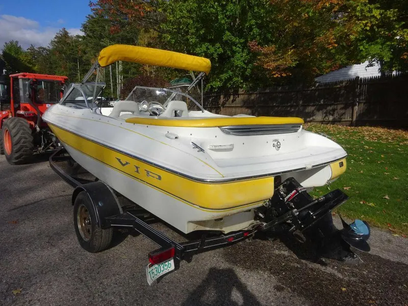 Slide: The Image of 2004 VIP 185 Vegas boat with yellow accents on a trailer. - 15