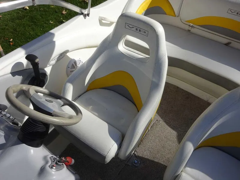 Slide: The Image of 2004 VIP 185 Vegas boat interior with white and yellow seats. - 16
