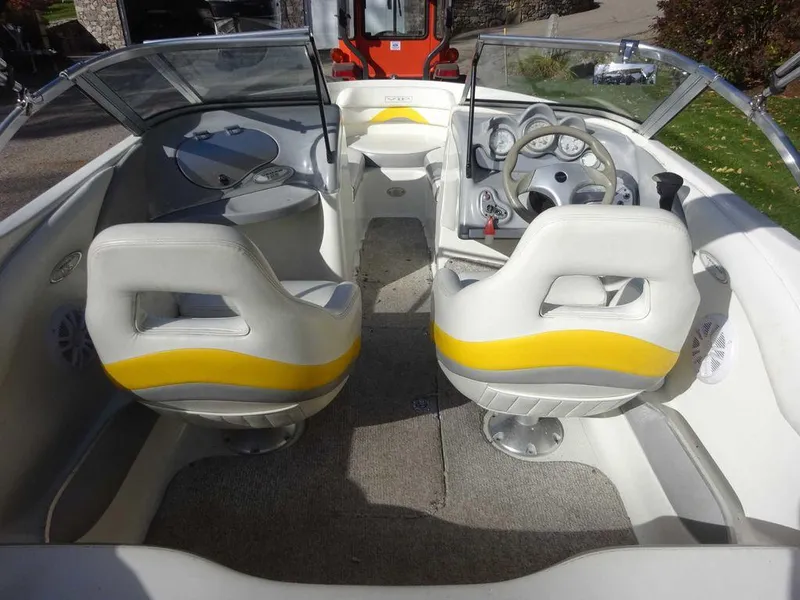 Slide: The Image of 2004 VIP 185 Vegas boat interior with white and yellow seats, steering wheel, and dashboard. - 17