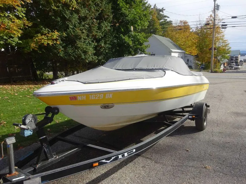 Slide: The Image of 2004 VIP 185 Vegas boat on trailer with cover, parked on a residential street. - 6