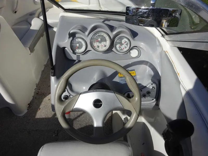 Slide: The Image of 2004 VIP 185 Vegas boat dashboard with steering wheel and gauges. - 7