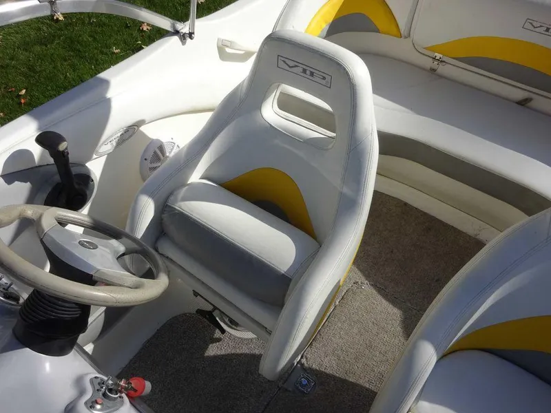 Slide: The Image of 2004 VIP 185 Vegas boat interior with white and yellow seats. - 9