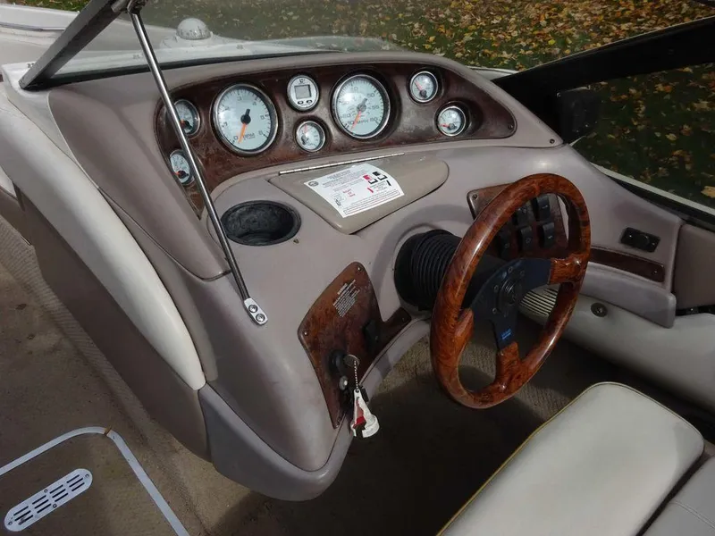 Slide: The Image of 2000 Regal 2100 LSR boat dashboard with wood trim and gauges. - 10