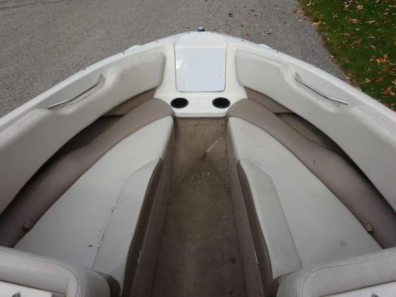 Slide: The Image of Interior of a 2000 Regal 2100 LSR boat with beige seating. - 13